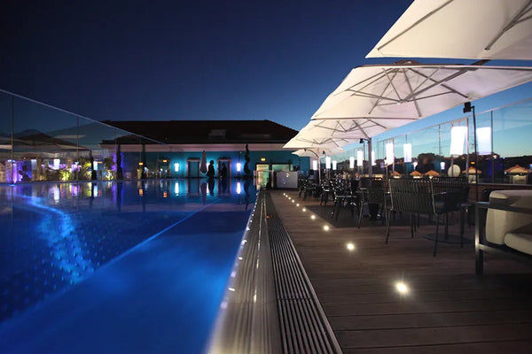 Piscine en inox éclairée de nuit sur la terrasse de l'hôtel Five Seas à Cannes, réalisation Steel and Style